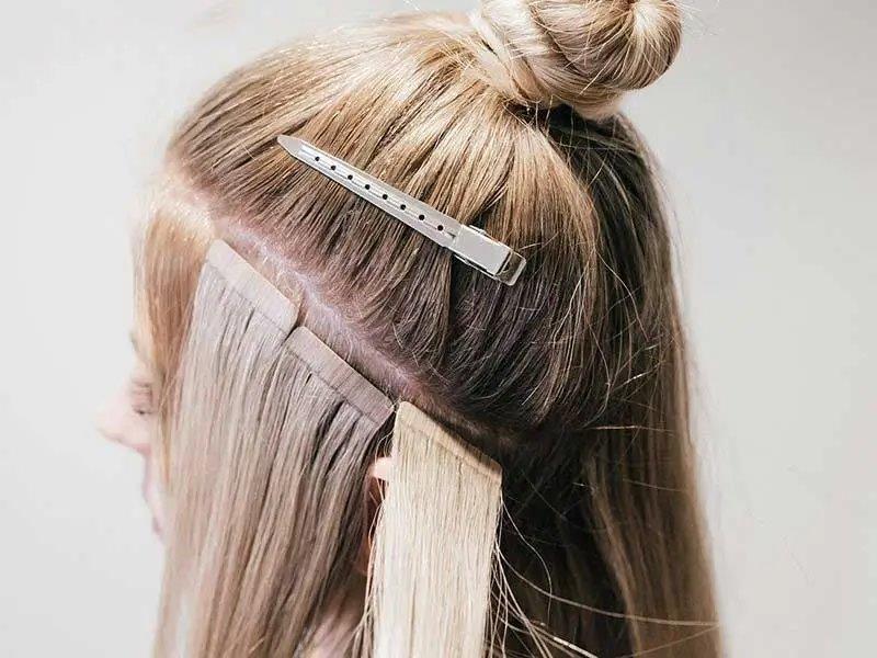 What is the procedure for applying tape-in hair extensions?