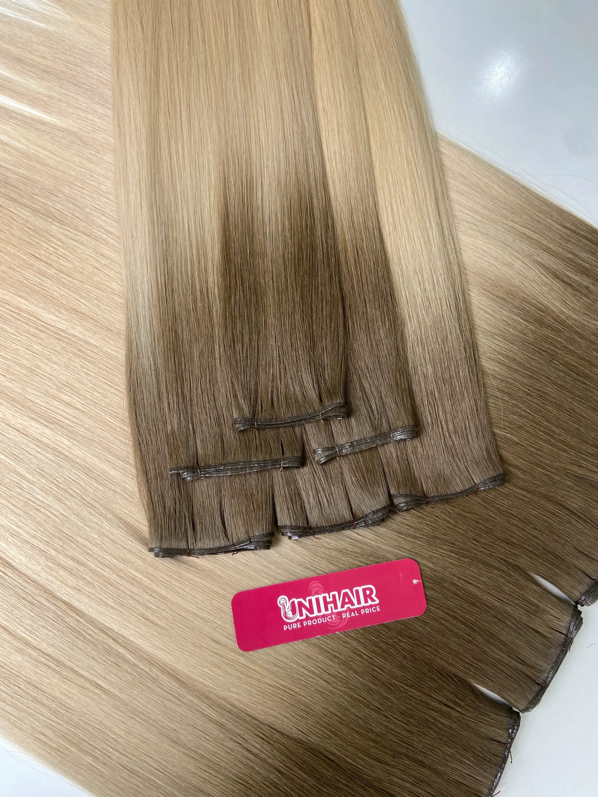 Genius Weft ultra-thin flexible weft construction close-up by Unihairvn Genius Weft ultra-thin flexible weft construction close-up by Unihairvn