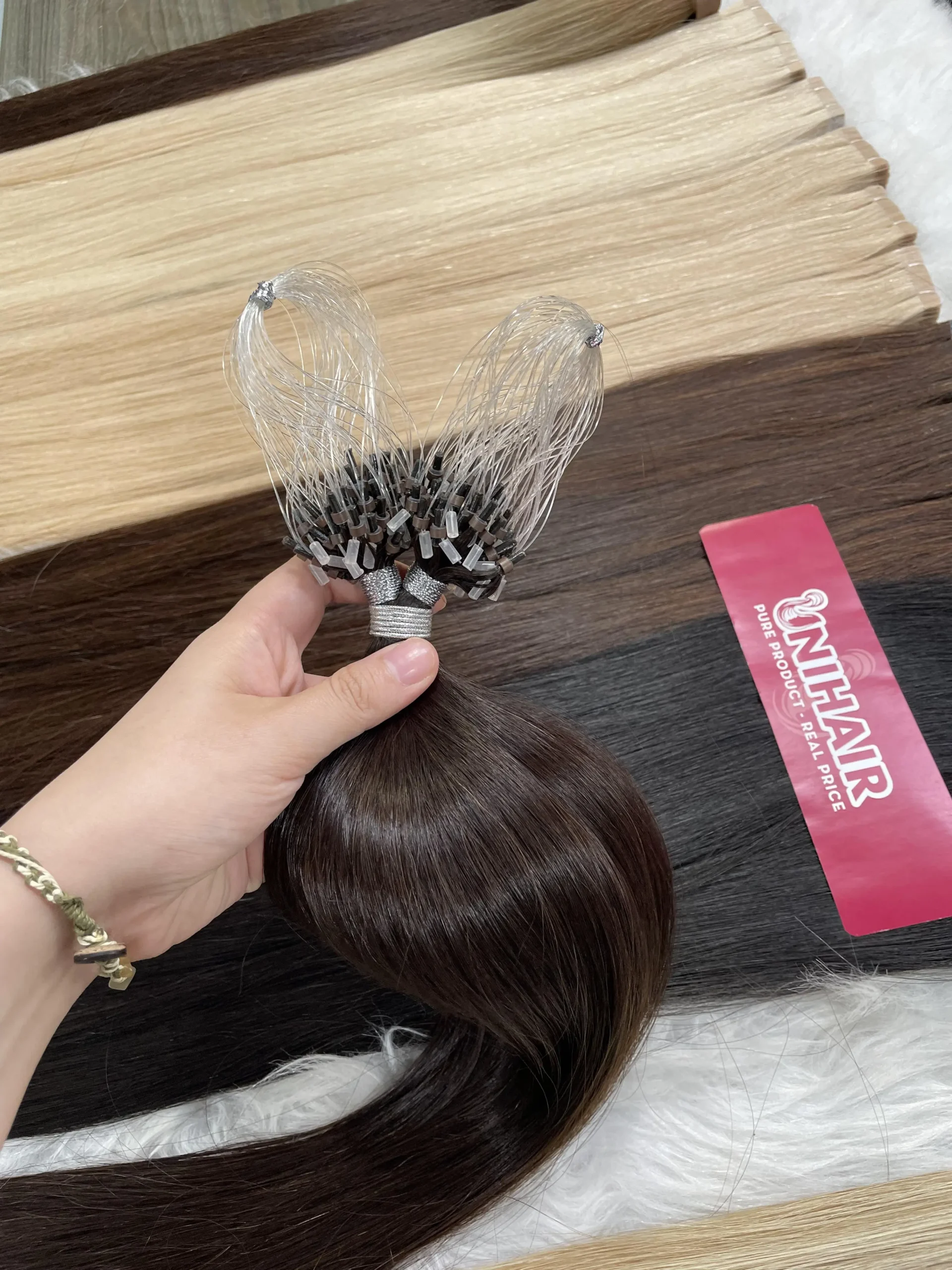 Micro Ring reusable bead hair extensions close-up with silicone-lined rings for salon installation Micro Ring reusable bead hair extensions close-up with silicone-lined rings for salon installation